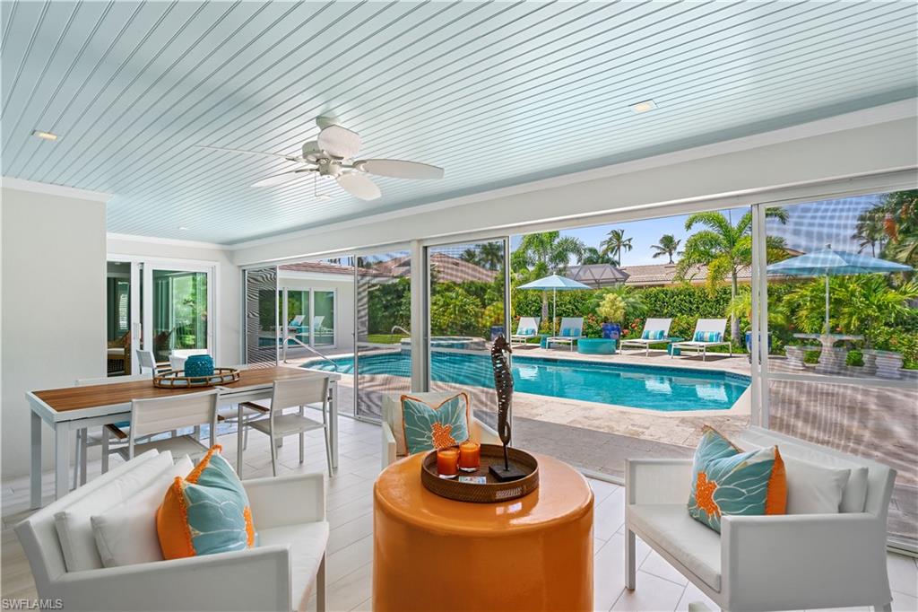 521 Turtle Hatch Road Naples, FL 34103 - Photo 26 of 34 a living room with patio furniture and a potted plant