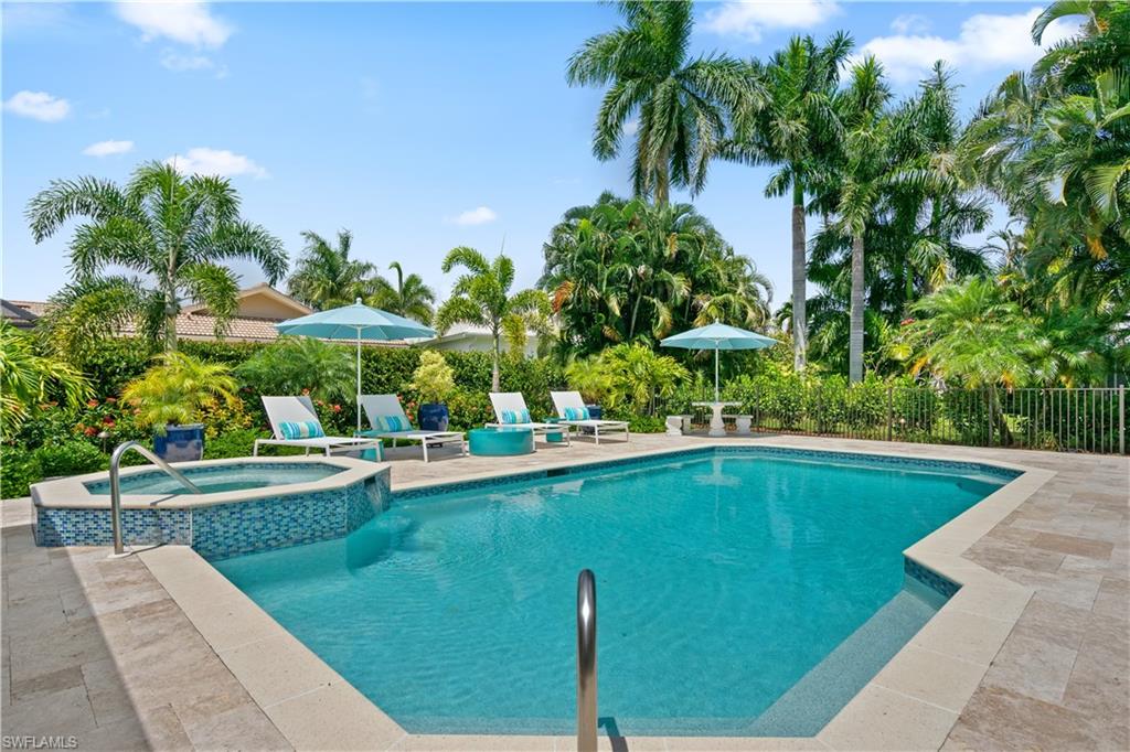 521 Turtle Hatch Road Naples, FL 34103 - Photo 28 of 34 a view of a swimming pool with a garden and plants