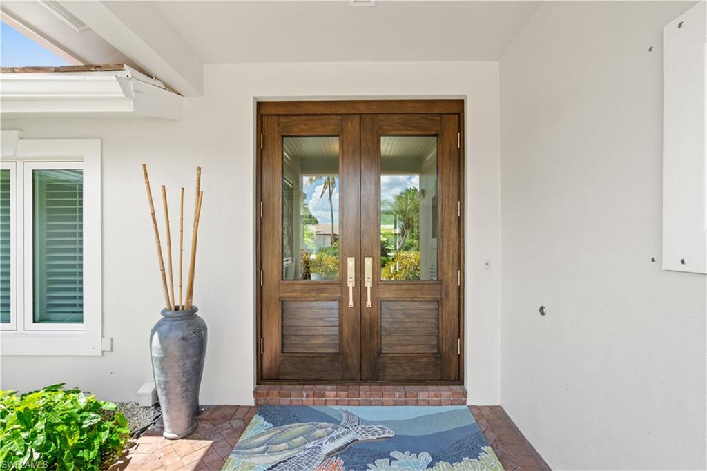 521 Turtle Hatch Road Naples, FL 34103 - Photo 3 of 34 a view of a hallway with a front door
