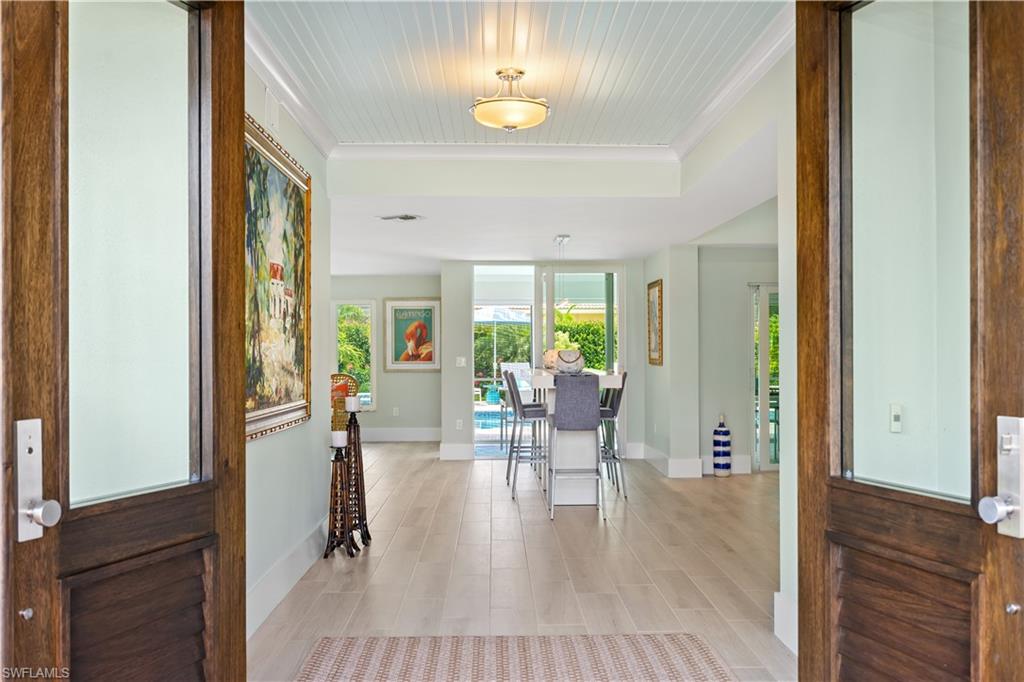 521 Turtle Hatch Road Naples, FL 34103 - Photo 4 of 34 a view of a livingroom with furniture window and wooden floor