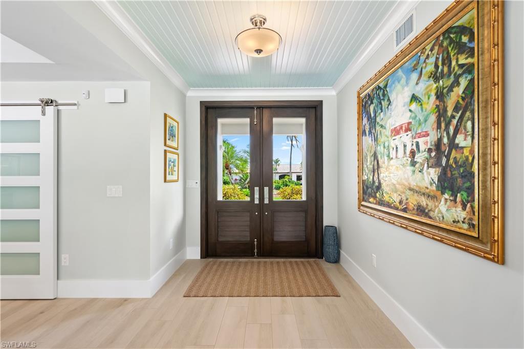 521 Turtle Hatch Road Naples, FL 34103 - Photo 5 of 34 a view of an entryway with wooden floor