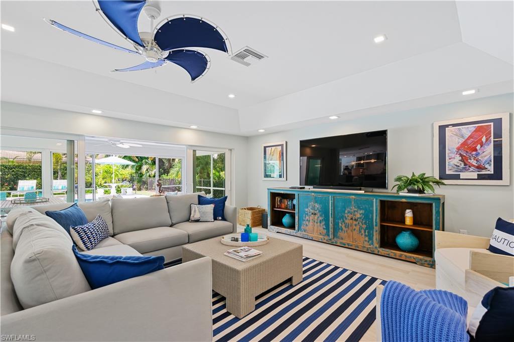 521 Turtle Hatch Road Naples, FL 34103 - Photo 6 of 34 a living room with furniture and a flat screen tv