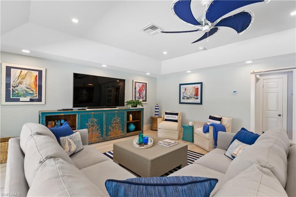 521 Turtle Hatch Road Naples, FL 34103 - Photo 7 of 34 a living room with furniture and a flat screen tv