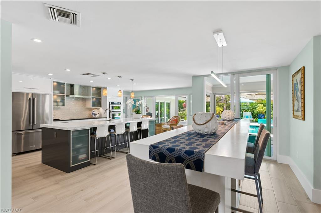 521 Turtle Hatch Road Naples, FL 34103 - Photo 8 of 34 a view of a dining room with furniture and a kitchen