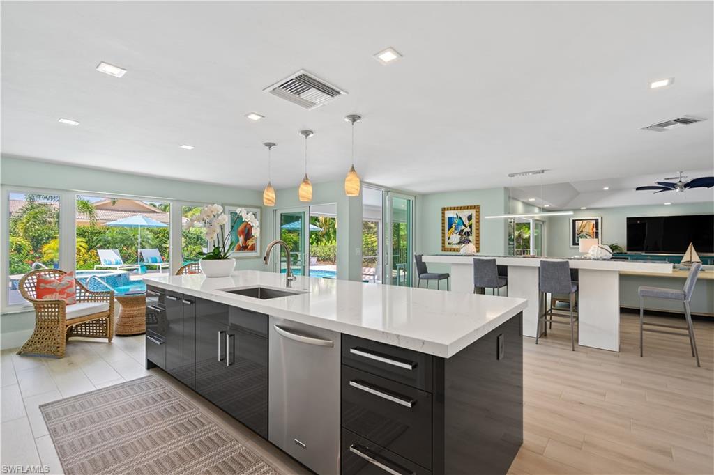 521 Turtle Hatch Road Naples, FL 34103 - Photo 9 of 34 a large kitchen with kitchen island a sink table and chairs