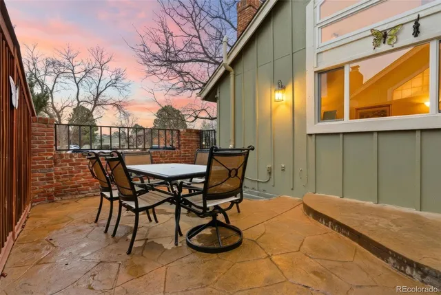 a view of a patio with table and chairs and potted plants