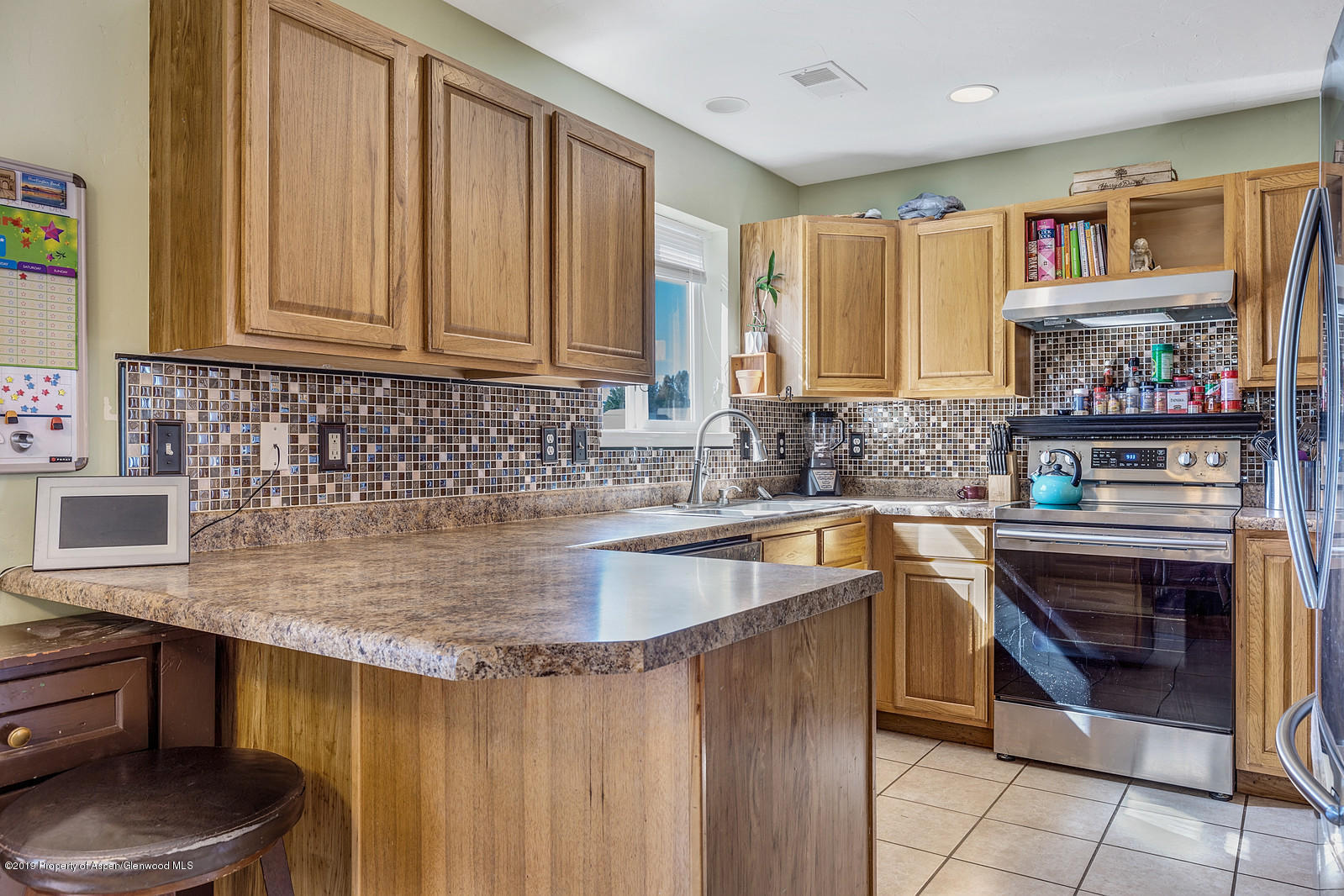 747 East 17th Street Rifle, CO 81650 - Photo 8 of 17 a kitchen with stainless steel appliances granite countertop a sink stove and cabinets