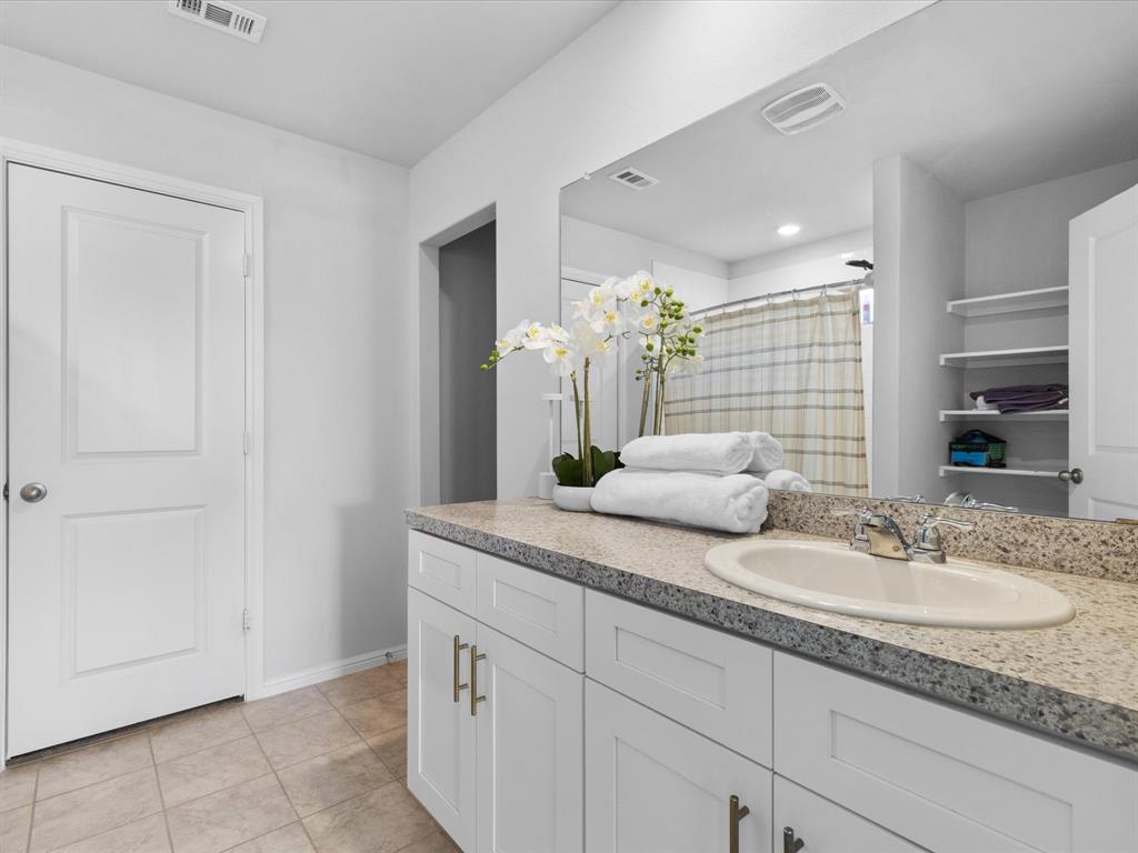 401 Attalla Street Azle, TX 76020 - Photo 13 of 24 a bathroom with a granite countertop sink and a mirror