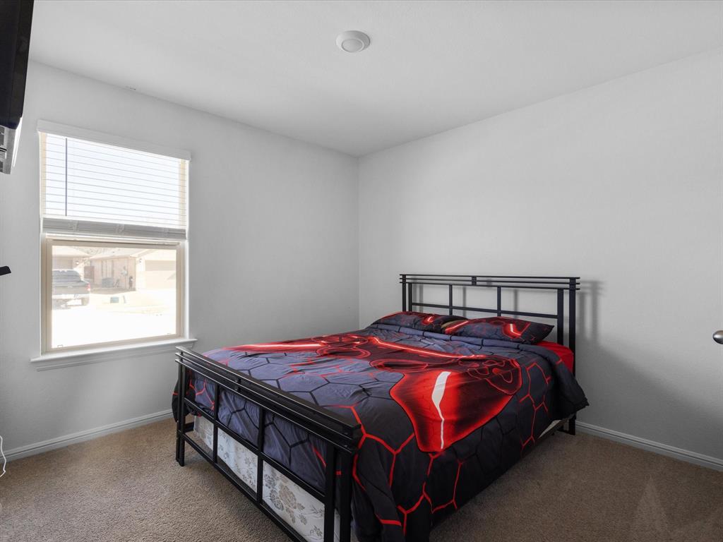 401 Attalla Street Azle, TX 76020 - Photo 14 of 24 a bed sitting in a bedroom next to a window