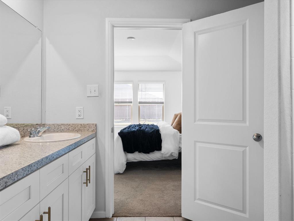 401 Attalla Street Azle, TX 76020 - Photo 15 of 24 a bedroom with a bed and a window