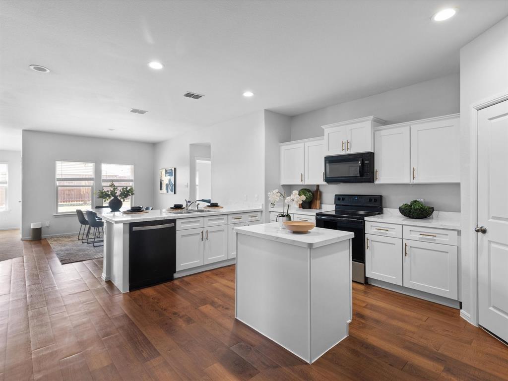 401 Attalla Street Azle, TX 76020 - Photo 3 of 24 a kitchen with sink a microwave and cabinets