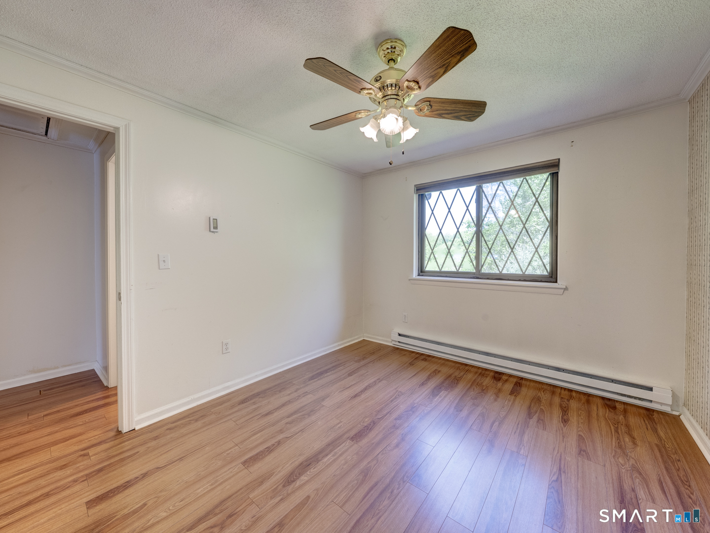 2 Branch Road, Unit 2C Thomaston, CT 06787 - Photo 17 of 26 a view of an empty room with wooden floor and a window