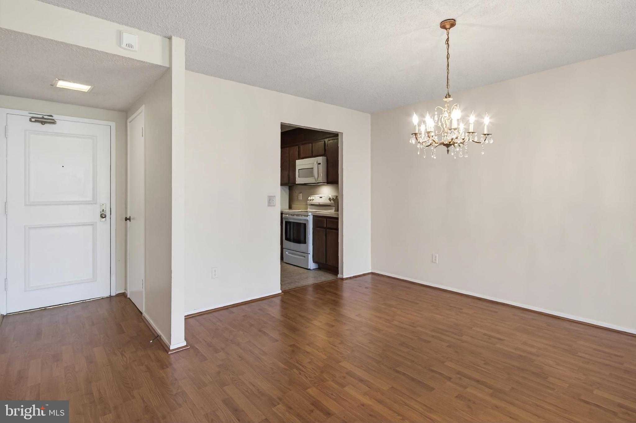6101 Edsall Road, Unit 1206 Alexandria, VA 22304 - Photo 14 of 52 a view of a room with wooden floor and kitchen space