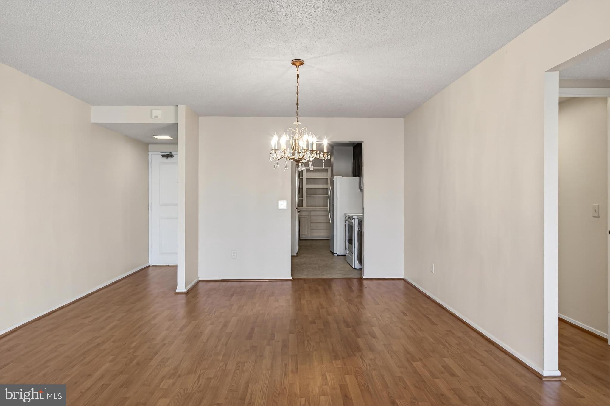 6101 Edsall Road, Unit 1206 Alexandria, VA 22304 - Photo 16 of 52 a view of a room with wooden floor chandelier and a window
