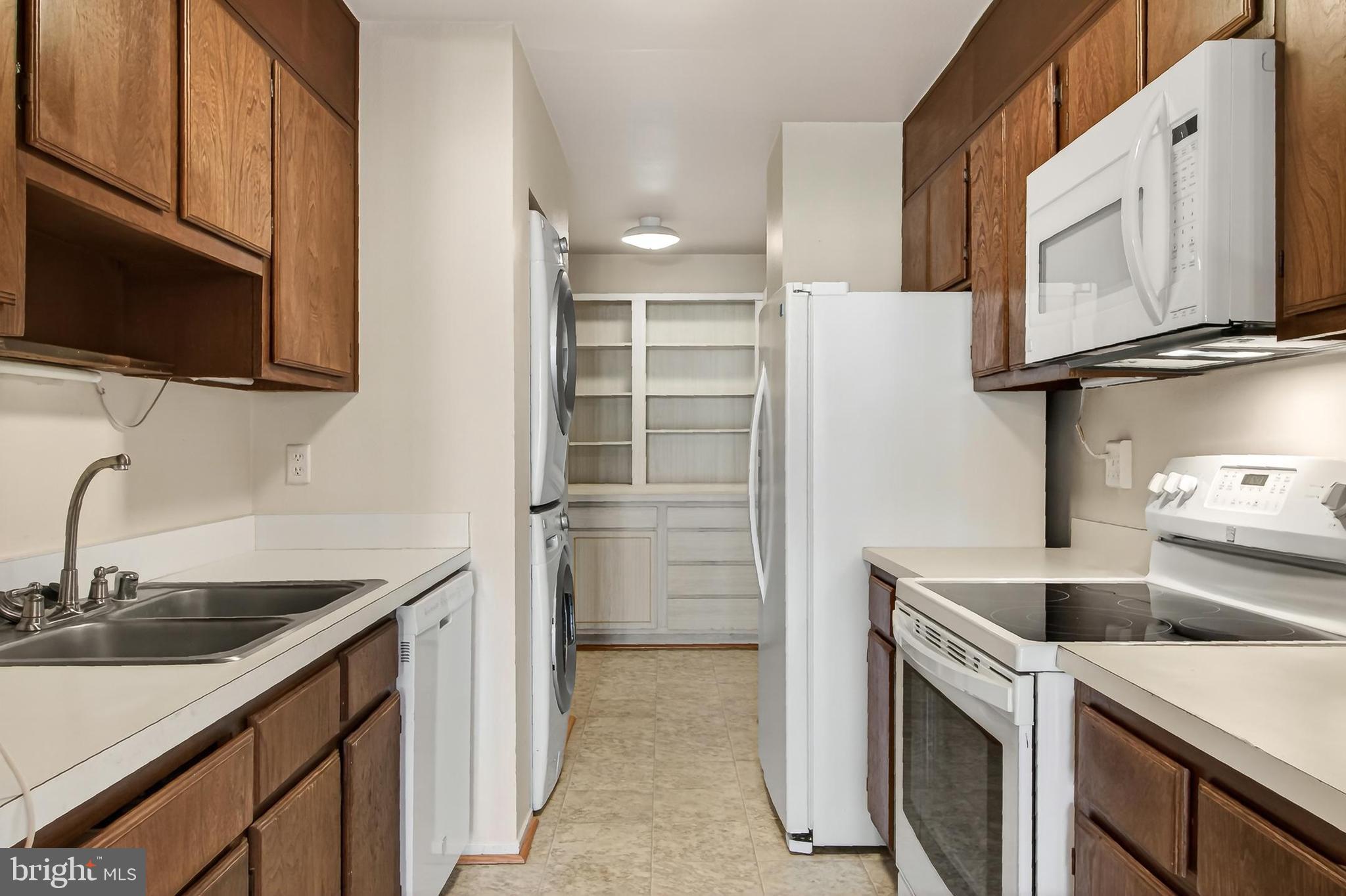 6101 Edsall Road, Unit 1206 Alexandria, VA 22304 - Photo 17 of 52 a kitchen with a sink and a refrigerator