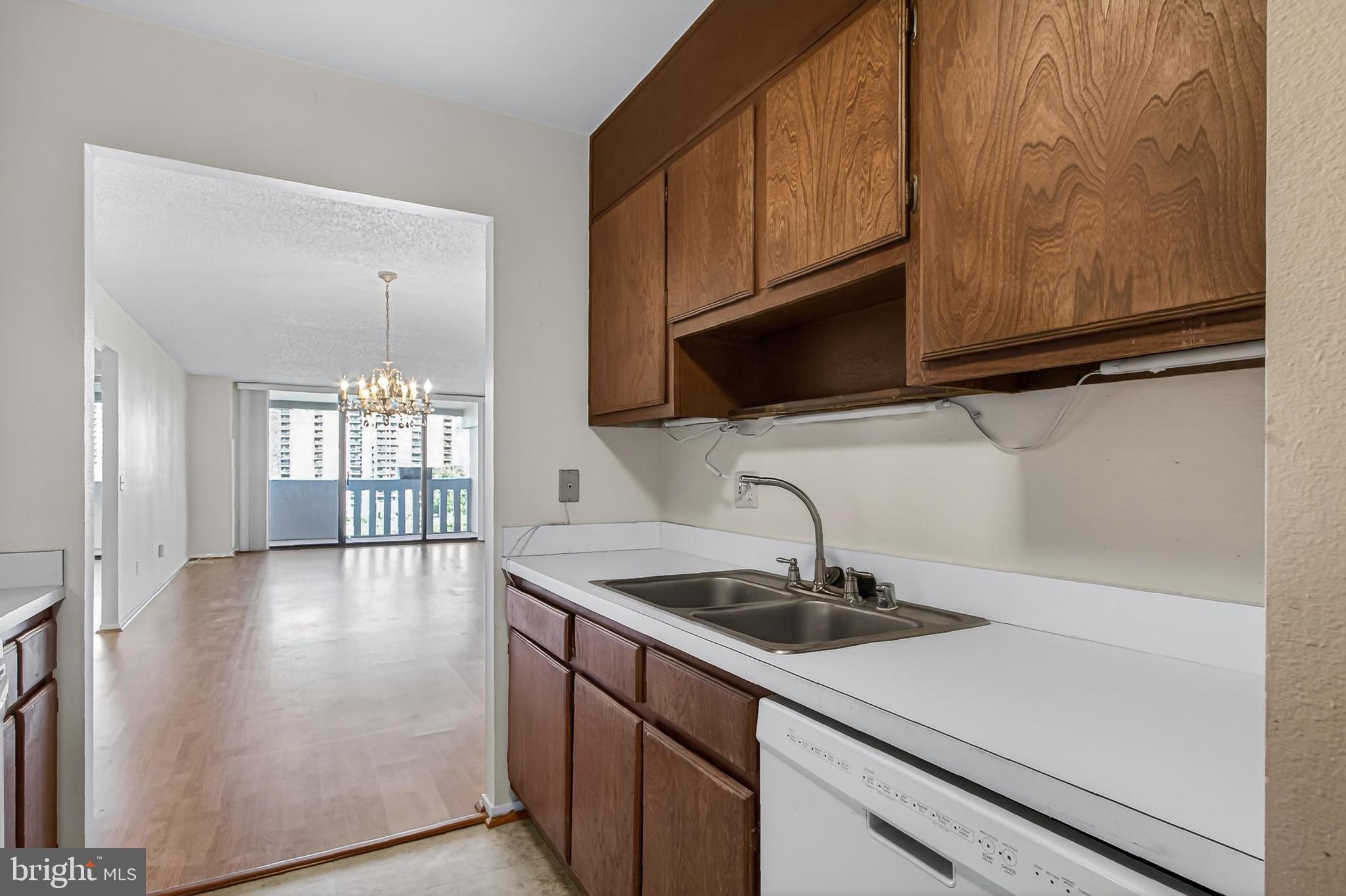 6101 Edsall Road, Unit 1206 Alexandria, VA 22304 - Photo 19 of 52 a kitchen with stainless steel appliances a sink a stove cabinets and a kitchen island