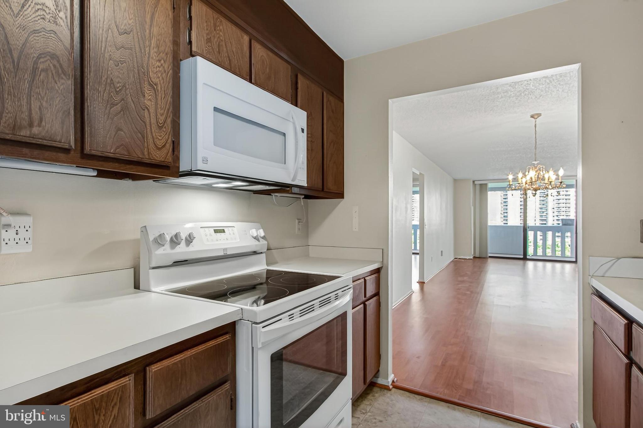 6101 Edsall Road, Unit 1206 Alexandria, VA 22304 - Photo 20 of 52 a kitchen with a stove microwave and sink