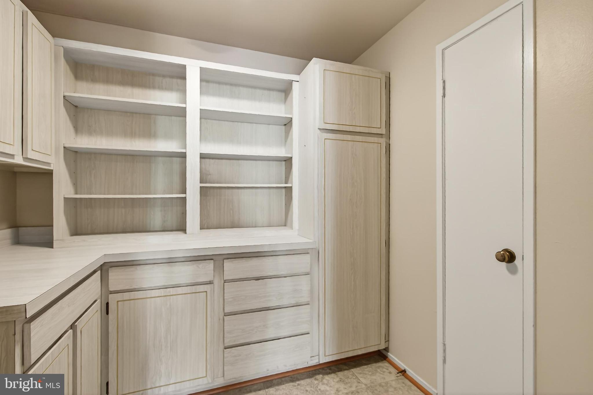 6101 Edsall Road, Unit 1206 Alexandria, VA 22304 - Photo 21 of 52 a kitchen with white cabinets and a refrigerator