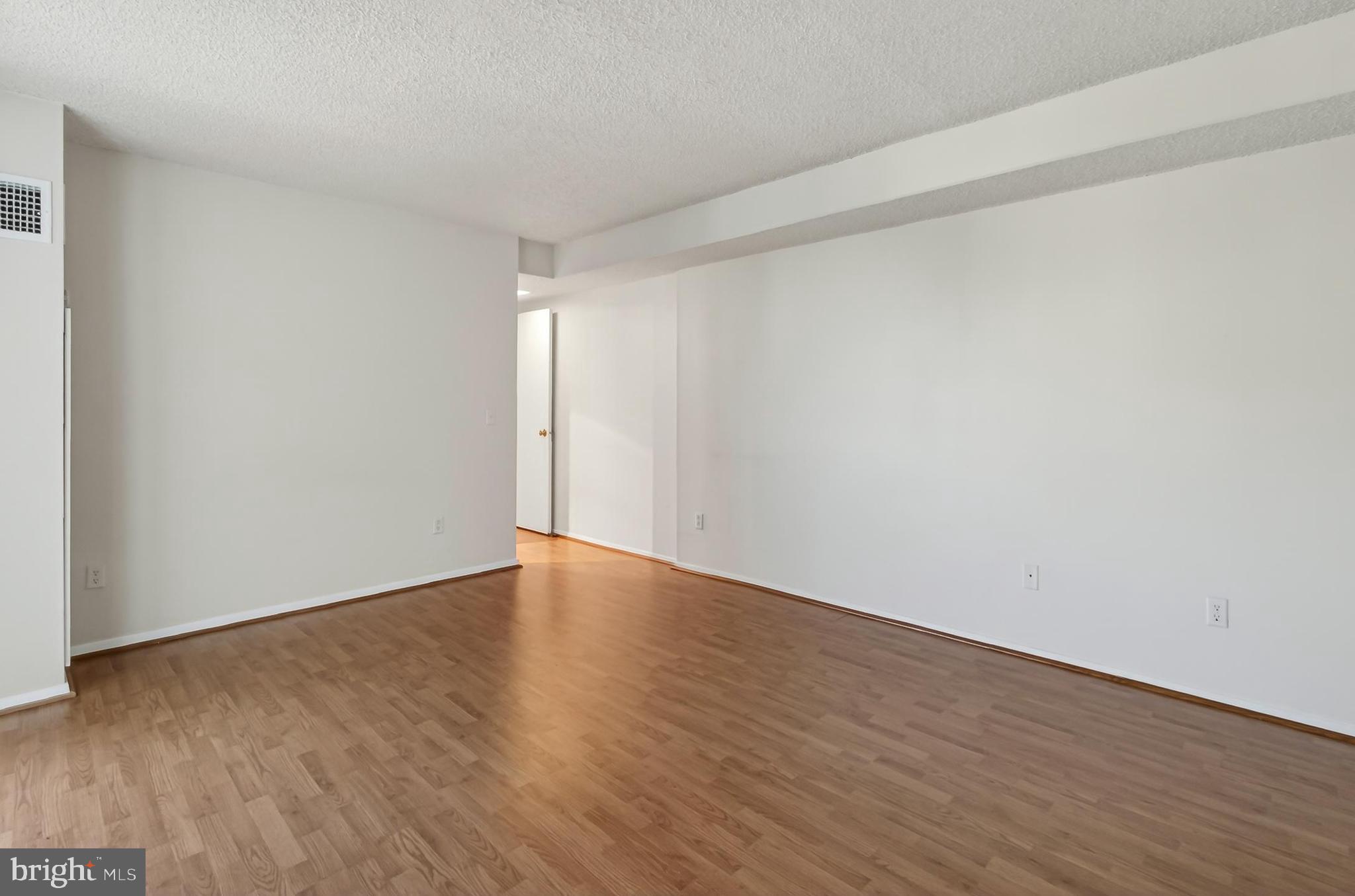 6101 Edsall Road, Unit 1206 Alexandria, VA 22304 - Photo 25 of 52 a view of an empty room and wooden floor