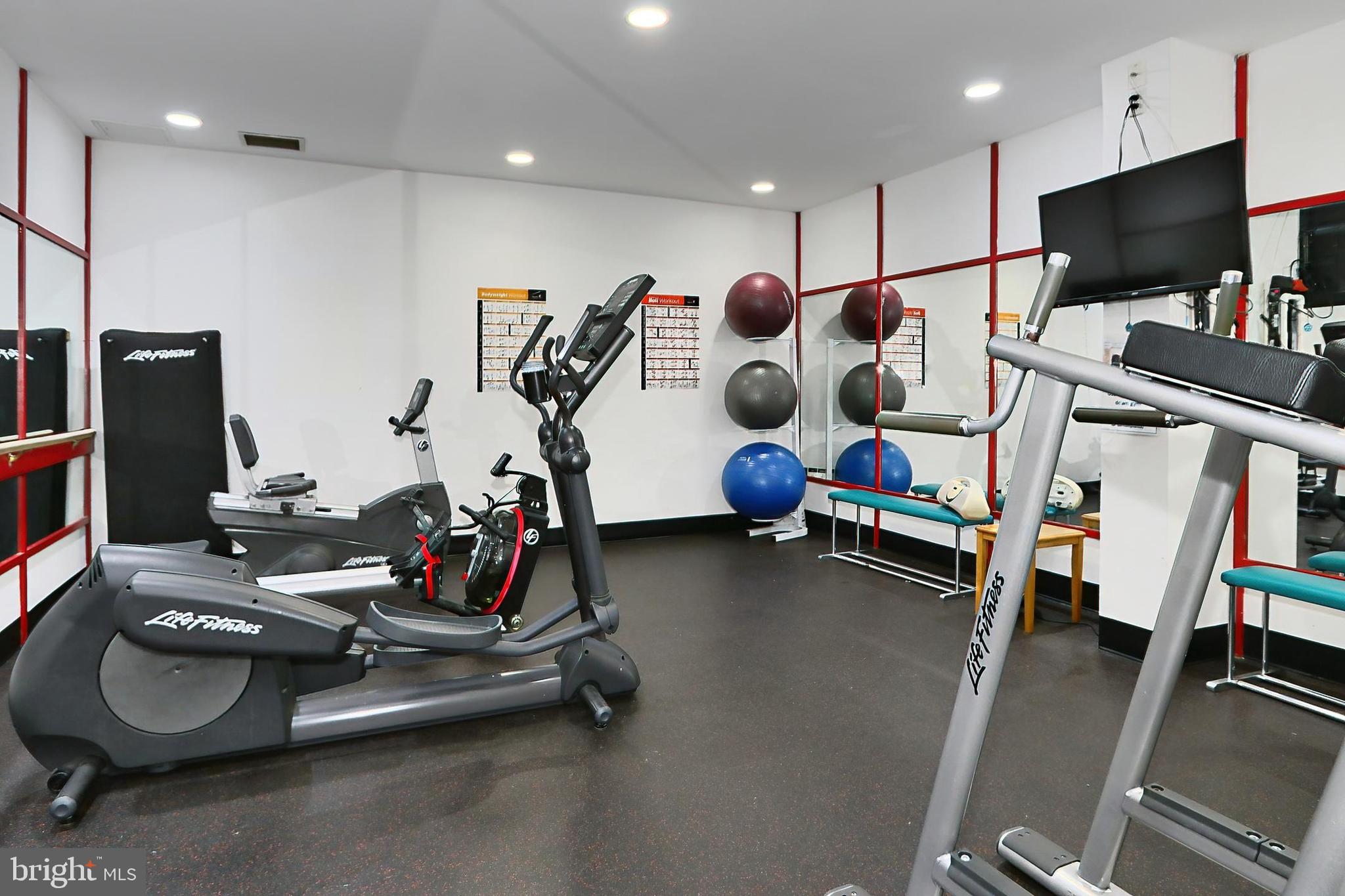 6101 Edsall Road, Unit 1206 Alexandria, VA 22304 - Photo 49 of 52 a room with gym equipment and a flat screen tv
