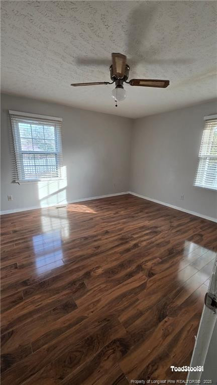 3023 Rouse Road Fayetteville, NC 28306 - Photo 11 of 12 an empty room with wooden floor chandelier fan and windows