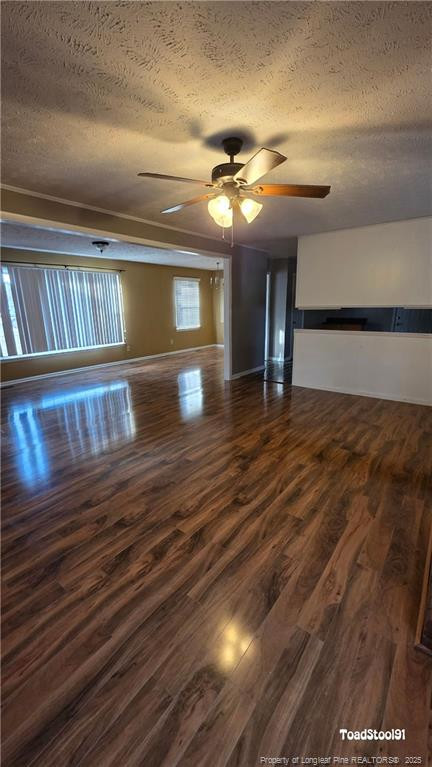 3023 Rouse Road Fayetteville, NC 28306 - Photo 5 of 12 a view of an empty room with wooden floor staircase and a kitchen view