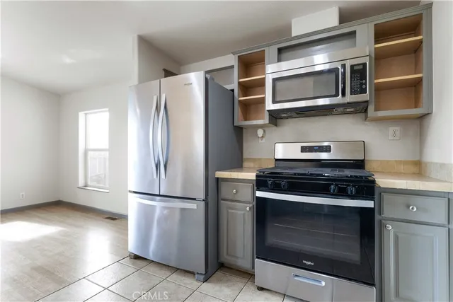 a kitchen with stainless steel appliances a stove and a microwave