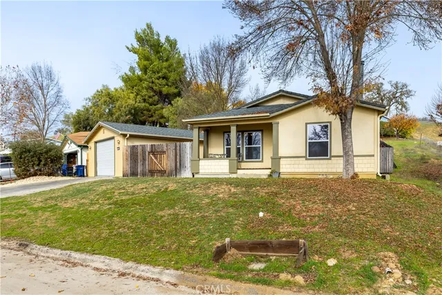 a front view of a house with a garden