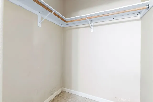 a view of backyard with large trees and wooden fence