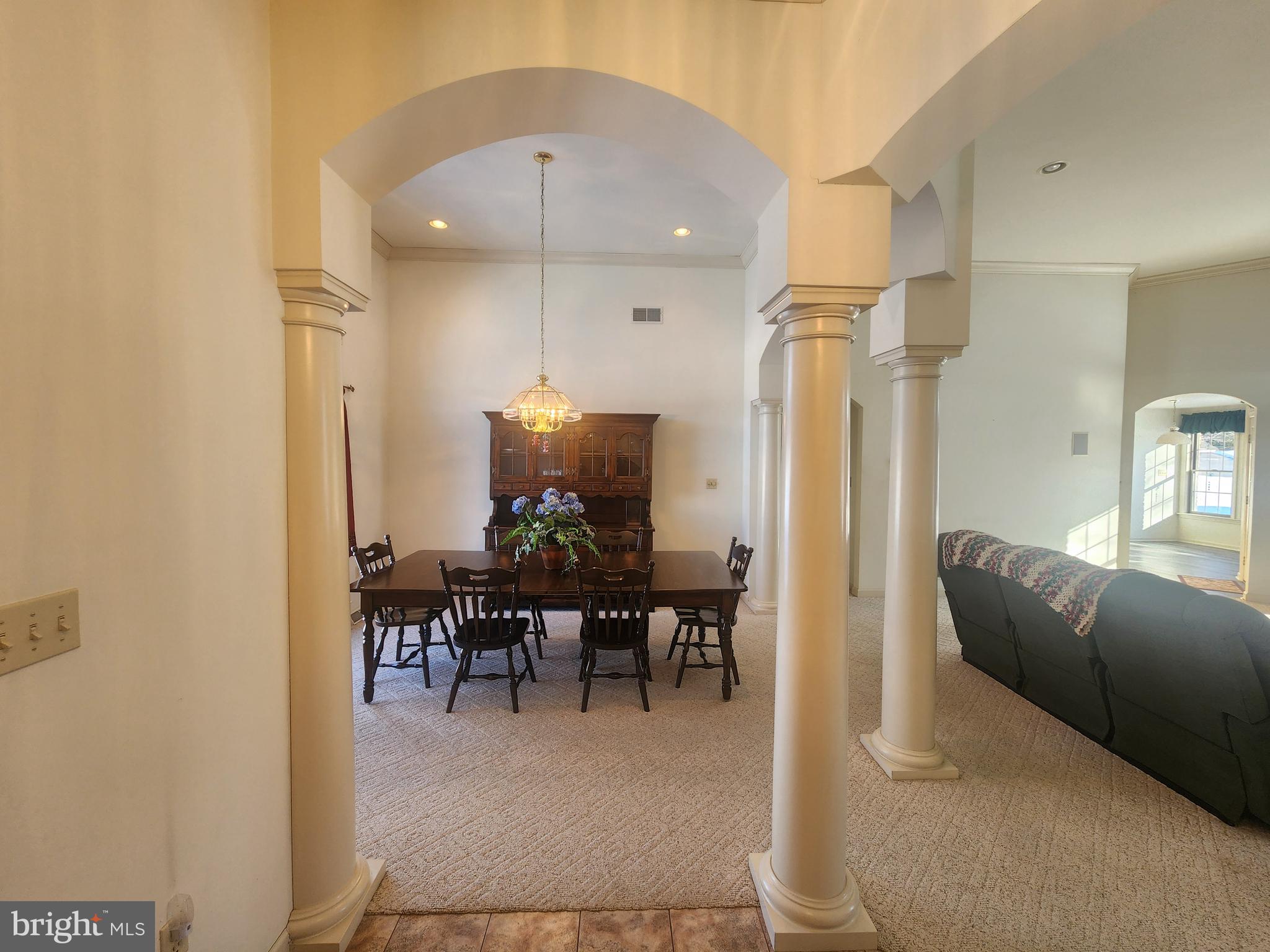 33 Tara Drive Lititz, PA 17543 - Photo 11 of 53 a living room with furniture a dining table and a chandelier
