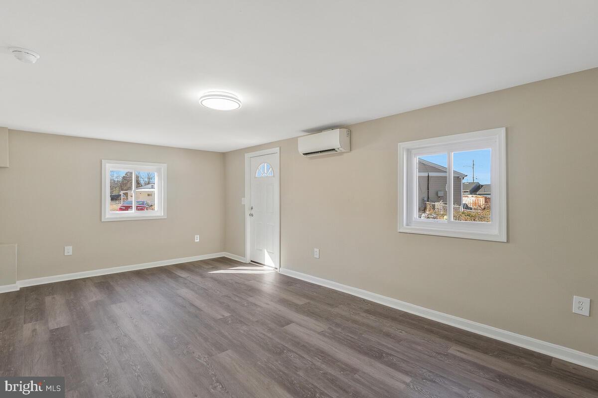 6200 Auth Road Suitland, MD 20746 - Photo 16 of 30 a view of an empty room with wooden floor and a window