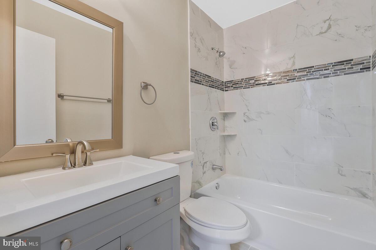 6200 Auth Road Suitland, MD 20746 - Photo 21 of 30 a bathroom with a sink a mirror toilet and bathtub