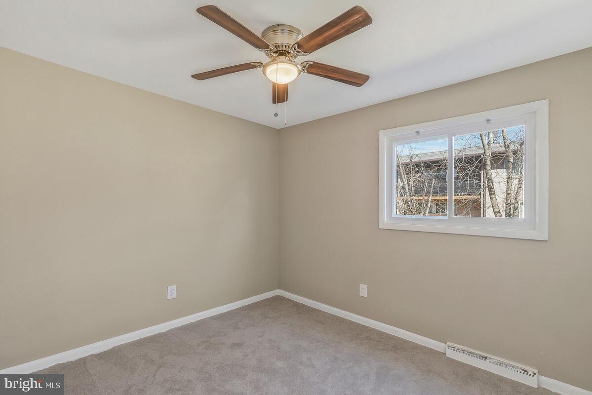 6200 Auth Road Suitland, MD 20746 - Photo 24 of 30 an empty room with a window and a fan