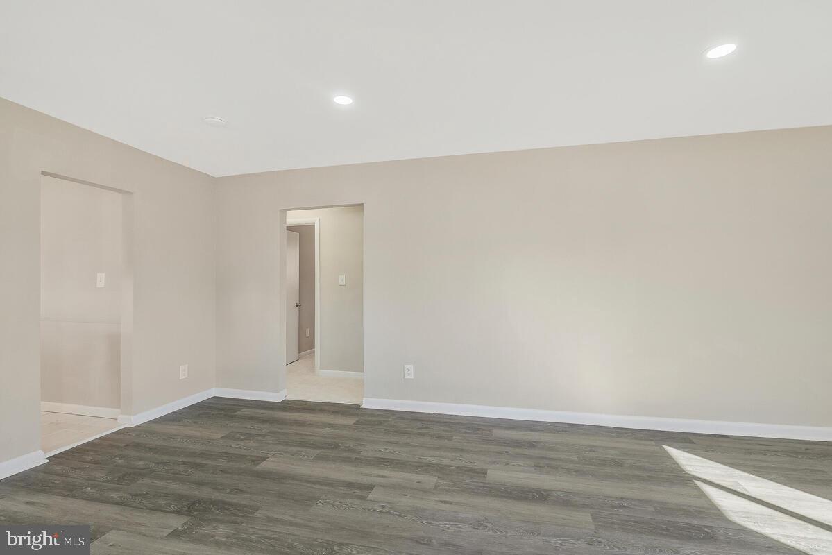 6200 Auth Road Suitland, MD 20746 - Photo 5 of 30 a view of an empty room with wooden floor and closet