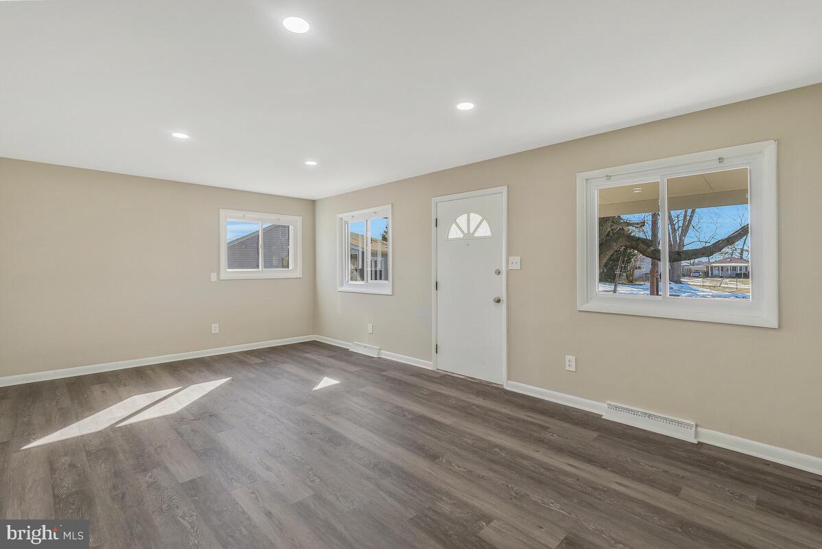 6200 Auth Road Suitland, MD 20746 - Photo 8 of 30 a view of an empty room with wooden floor and a window