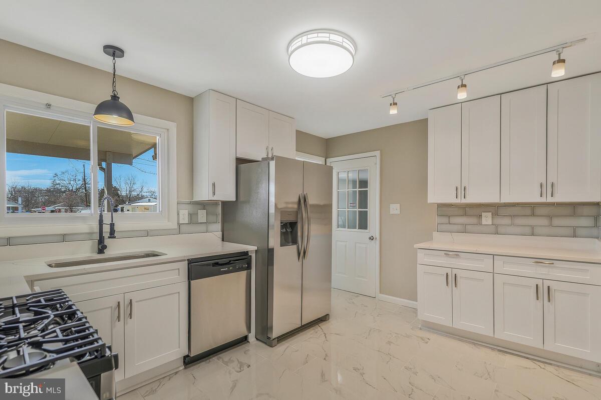 6200 Auth Road Suitland, MD 20746 - Photo 9 of 30 a kitchen with a sink stainless steel appliances and cabinets