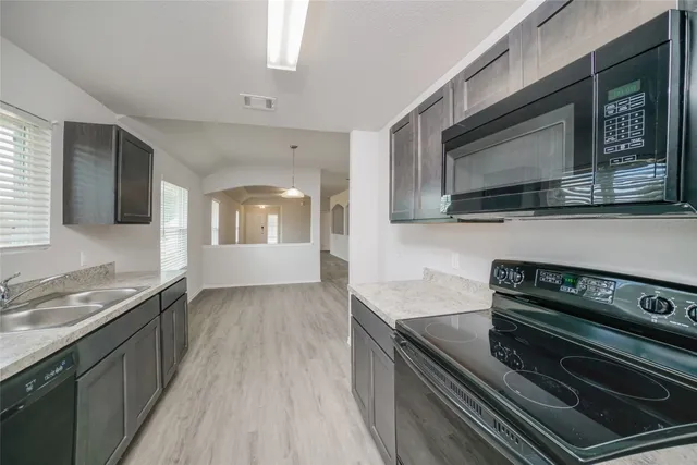 a kitchen with a stove microwave and sink