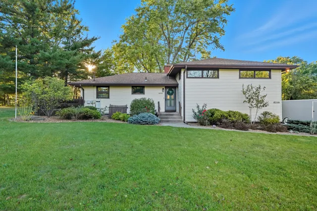 a view of a house with garden and yard