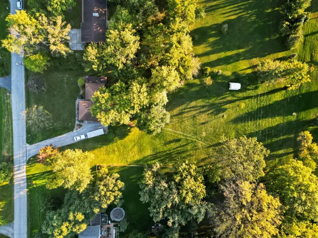 an aerial view of a house with swimming pool garden and patio