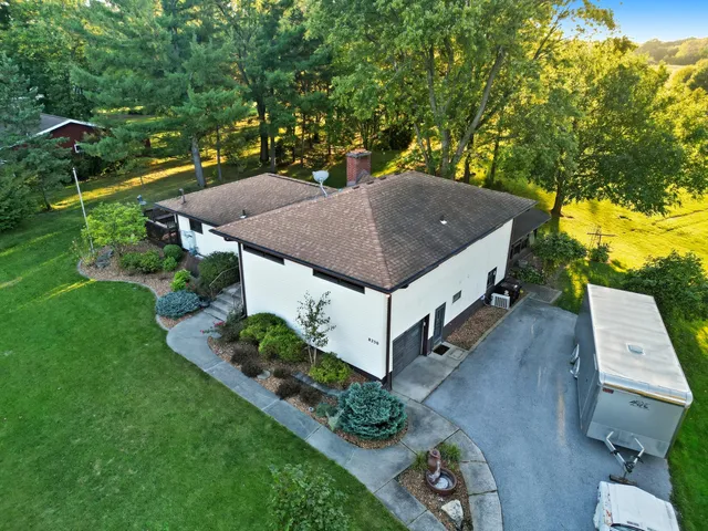 a view of a bedroom with furniture and windows
