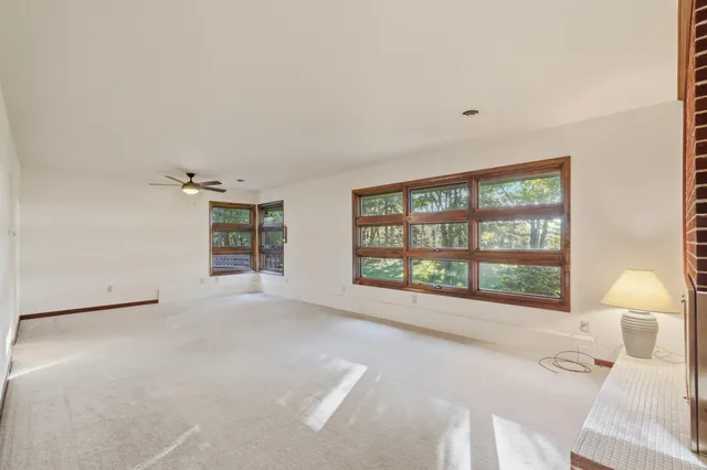 a view of a livingroom with a ceiling fan and window