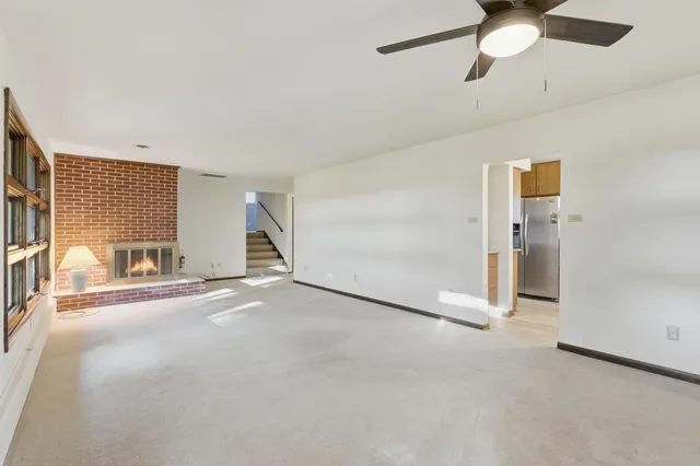 a kitchen with stainless steel appliances a stove refrigerator and a window