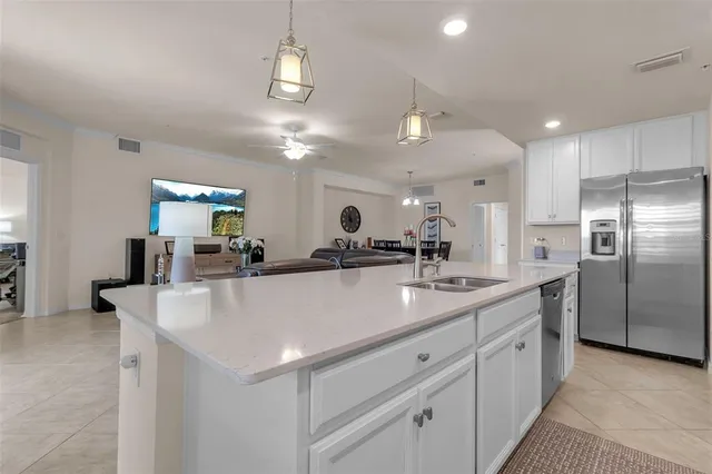 a kitchen with a sink a counter top space cabinets and stainless steel appliances