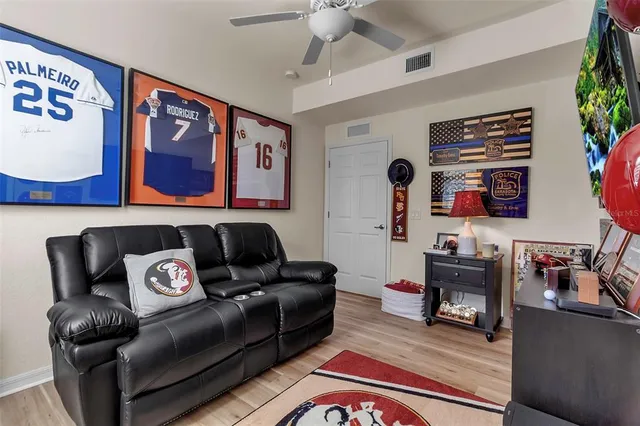 a bathroom with a sink a toilet a large mirror and shower curtain