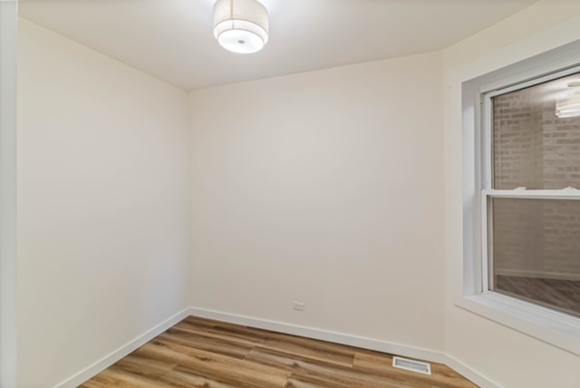 1018 North Harding Avenue Chicago, IL 60651 - Photo 15 of 38 a view of a small space with wooden floor and a window