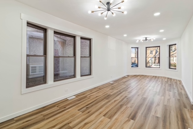 1018 North Harding Avenue Chicago, IL 60651 - Photo 2 of 38 a view of an empty room with window and wooden floor
