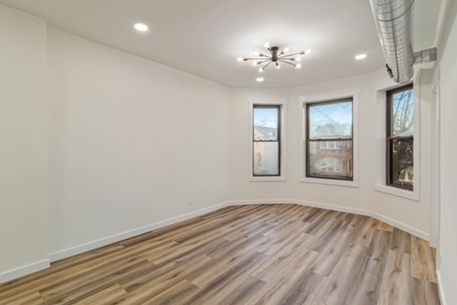 1018 North Harding Avenue Chicago, IL 60651 - Photo 23 of 38 wooden floor in an empty room with a window