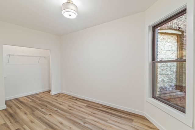 1018 North Harding Avenue Chicago, IL 60651 - Photo 29 of 38 a view of empty room with wooden floor and fan