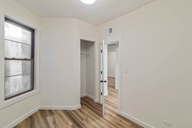 1018 North Harding Avenue Chicago, IL 60651 - Photo 32 of 38 a view of a room with wooden floor and windows
