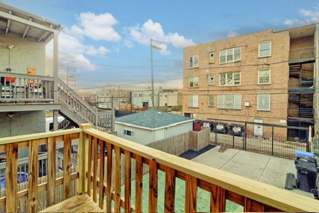1018 North Harding Avenue Chicago, IL 60651 - Photo 33 of 38 a view of a balcony with two chairs and a table